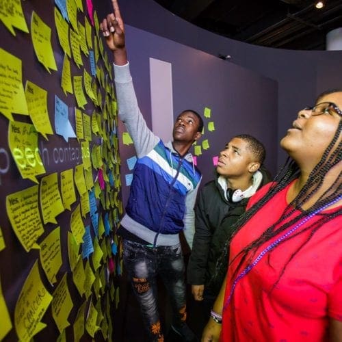 9th Graders reading post-it notes at NMAJH