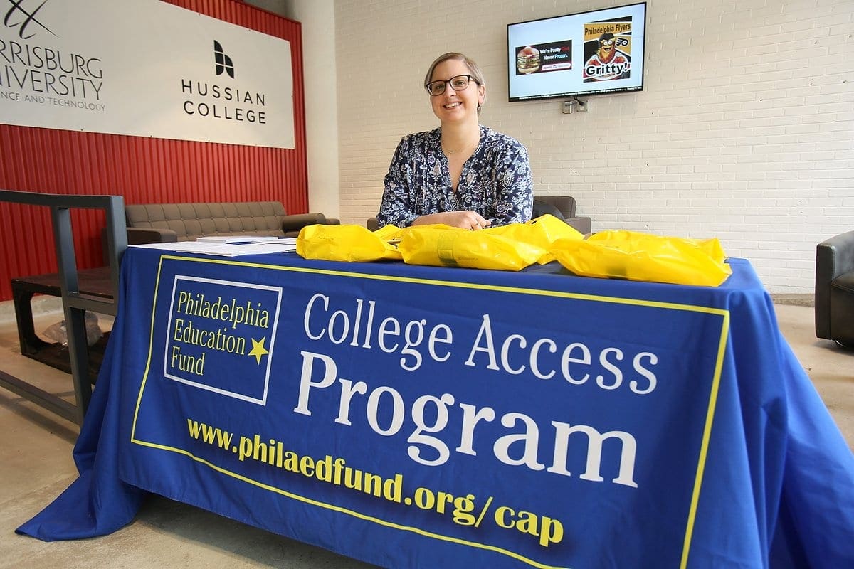 Kelly Staskel smiling at registration table at CAP event