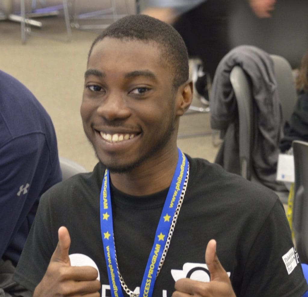 CAP student signaling double "thumbs up" at Know Before You Go event