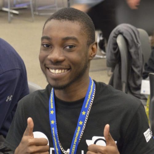 CAP student signaling double "thumbs up" at Know Before You Go event